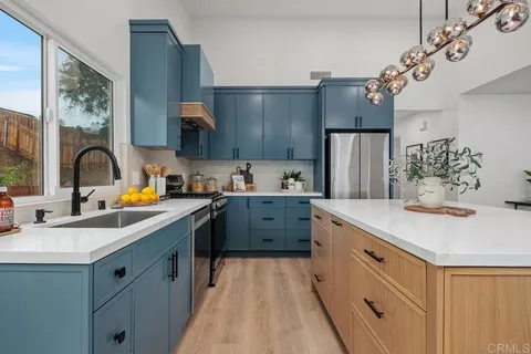a kitchen with a sink stove and refrigerator