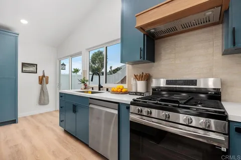 a kitchen with stainless steel appliances granite countertop a stove and a sink
