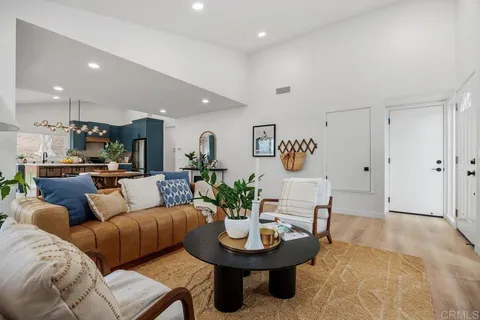 a living room with furniture kitchen view and a dining table