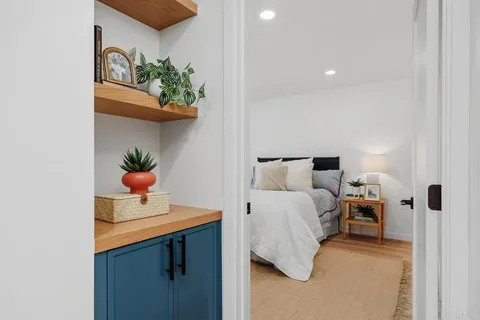 a bedroom with bed and flowerpot