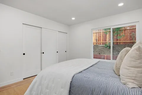 a bedroom with a bed and a large window