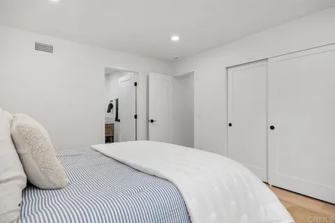 a bedroom with a bed and a chair