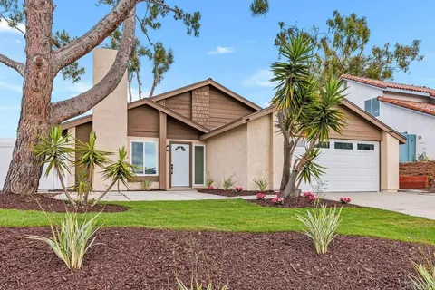 a view of a house with a yard and plants