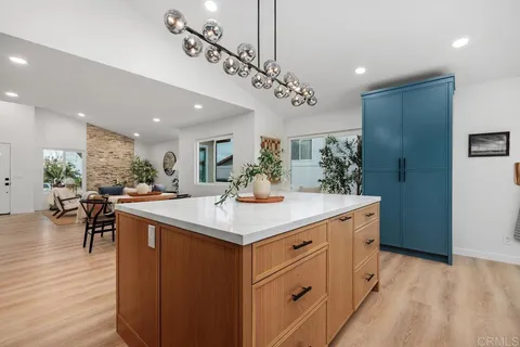 a kitchen with a sink a counter space and a dining table