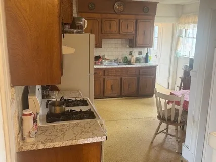 a kitchen with a sink a stove and a refrigerator
