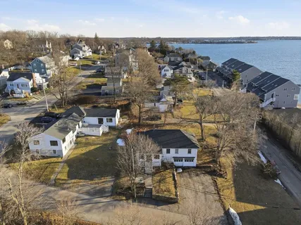 an aerial view of a house with a yard