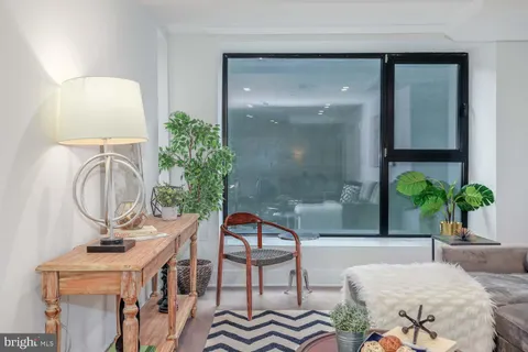 a living room with furniture a potted plant and a sink