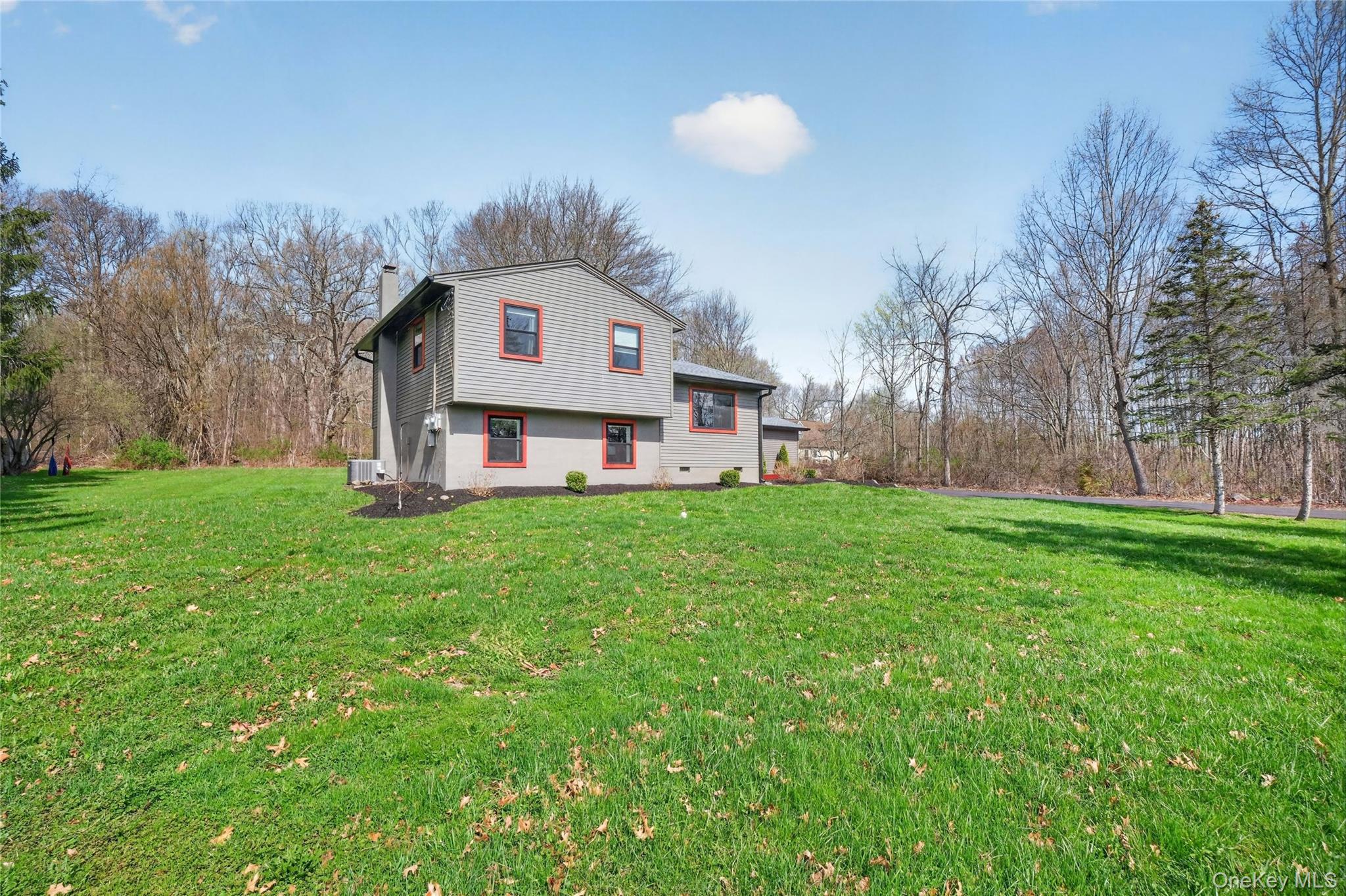 457 Forest Road Wallkill, NY 12589 - Photo 2 of 44 a front view of house with yard and trees in the background