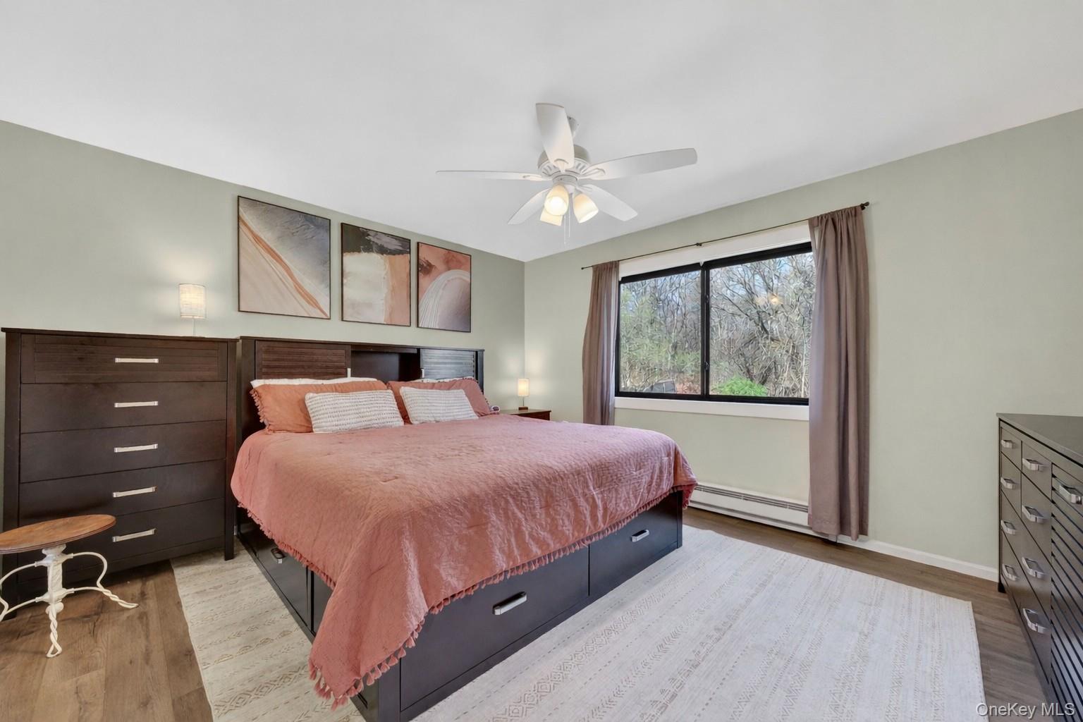 457 Forest Road Wallkill, NY 12589 - Photo 21 of 44 a bedroom with a large bed and a chandelier