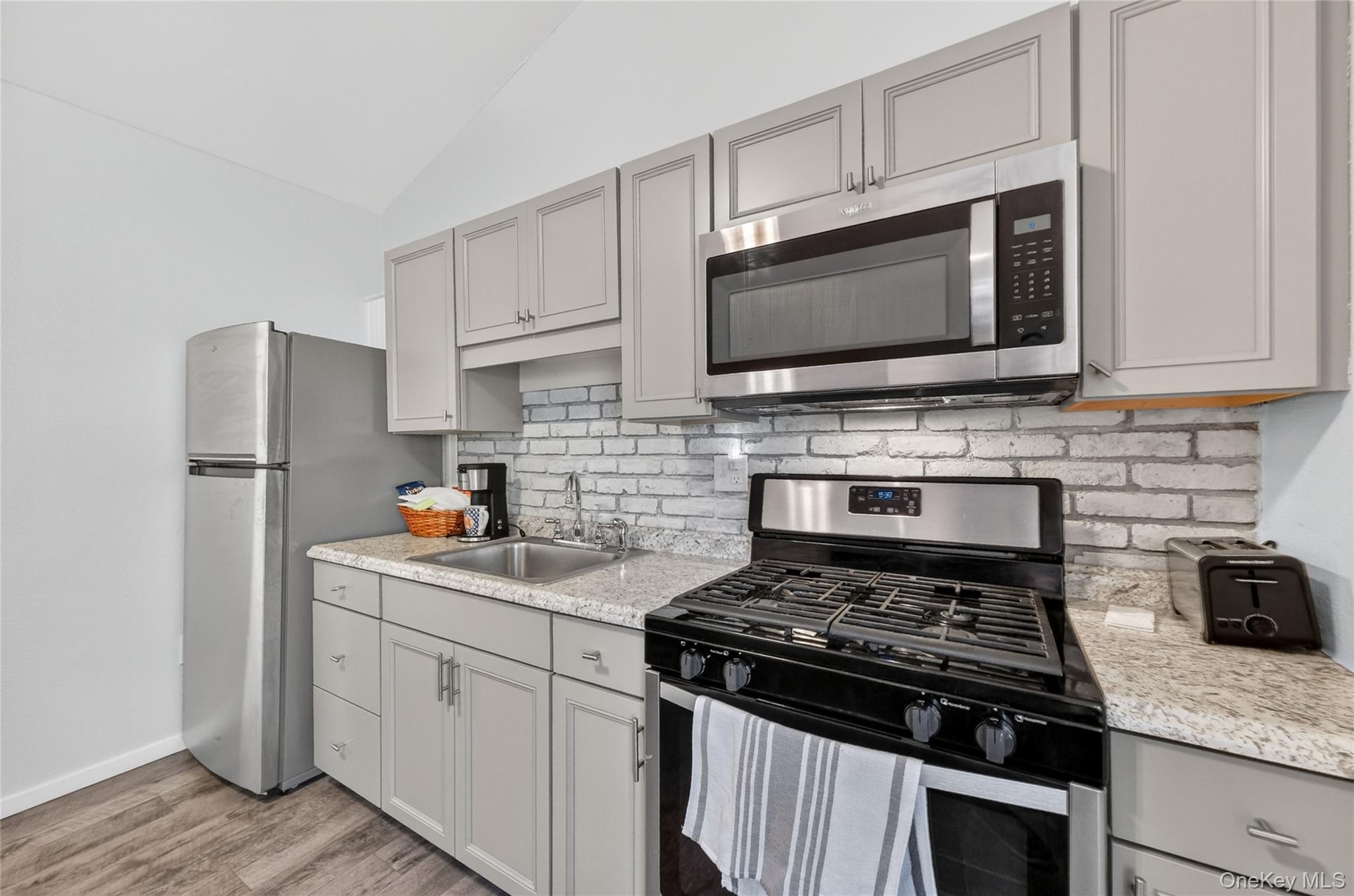 457 Forest Road Wallkill, NY 12589 - Photo 30 of 44 a kitchen with cabinets stainless steel appliances and wooden cabinets