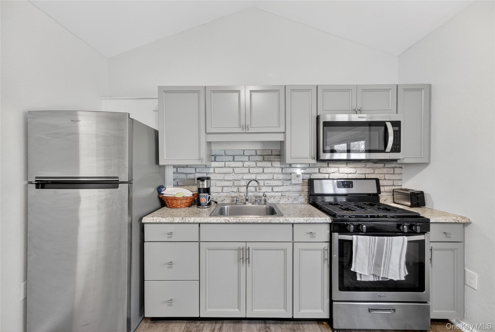 457 Forest Road Wallkill, NY 12589 - Photo 31 of 44 a kitchen with white cabinets stainless steel appliances and a refrigerator