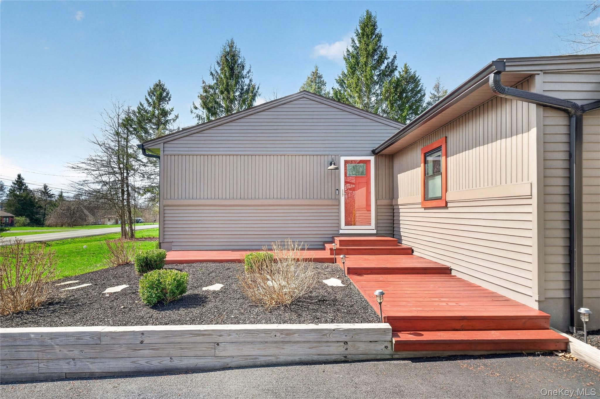 457 Forest Road Wallkill, NY 12589 - Photo 7 of 44 a front view of a house with garden