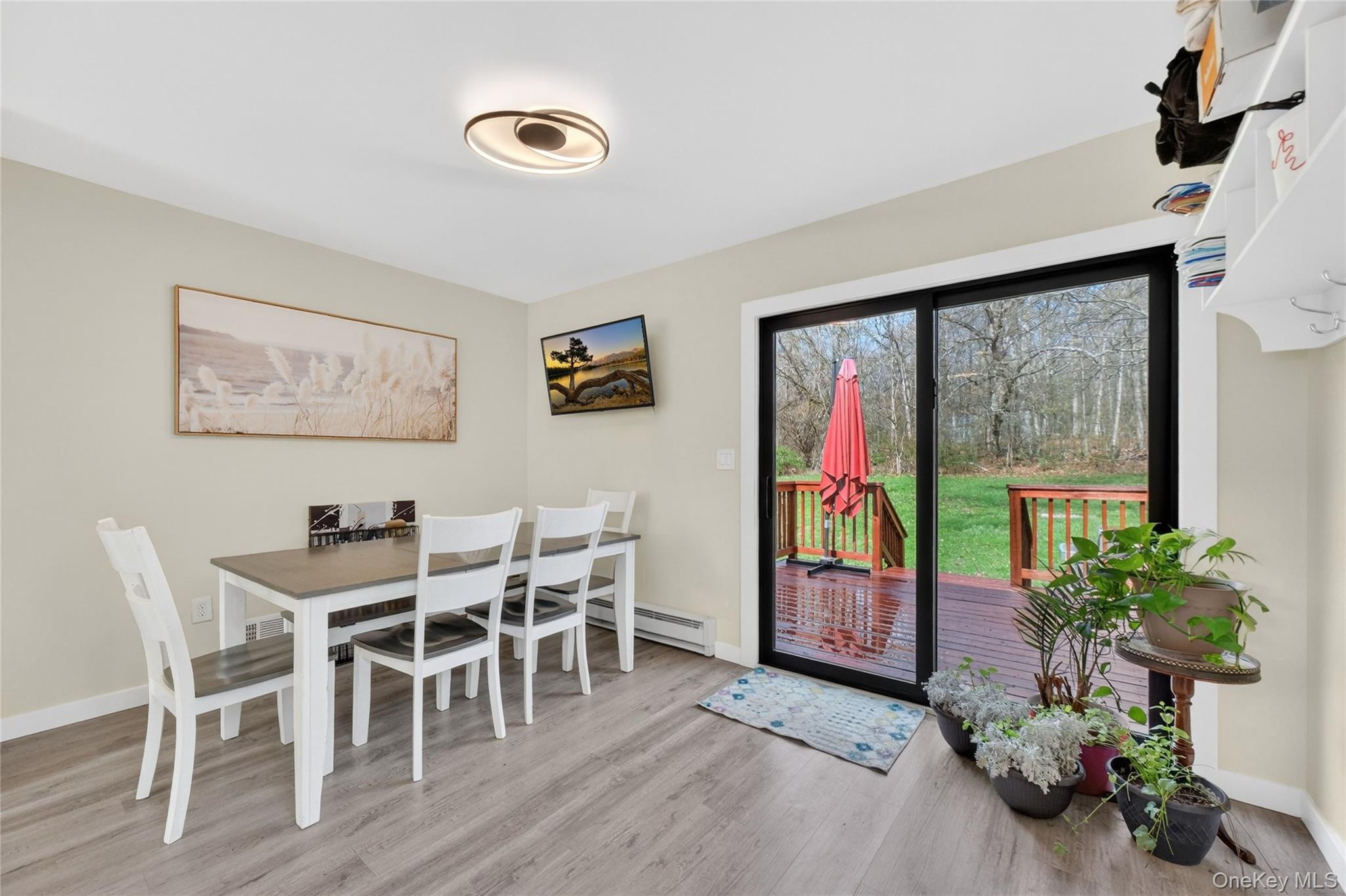 457 Forest Road Wallkill, NY 12589 - Photo 10 of 44 a view of a dining room with furniture window and wooden floor