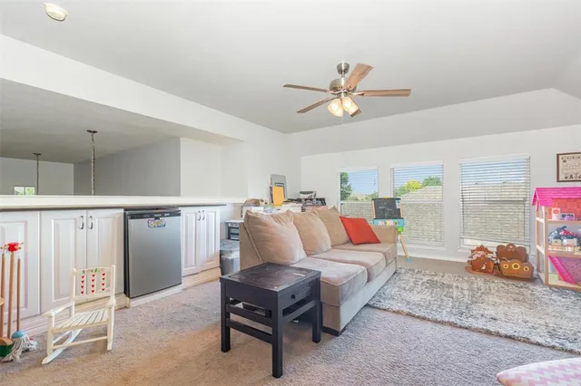 a living room with furniture a ceiling fan and a rug