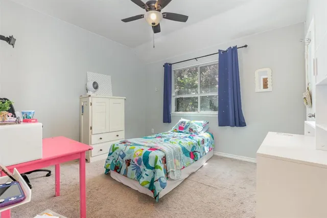 a bedroom with a bed and a table in it