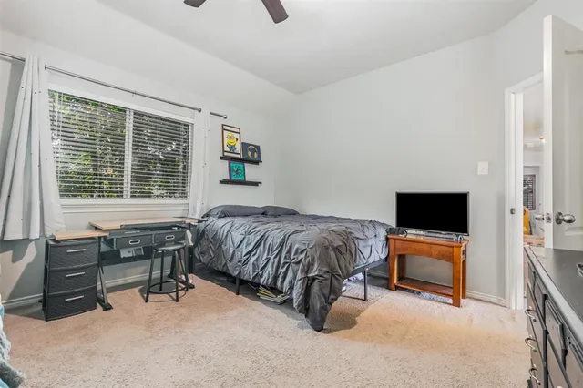 a bedroom with a bed and a flat tv screen