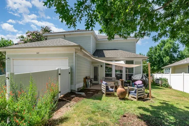 a view of a patio with table and chairs under an umbrella