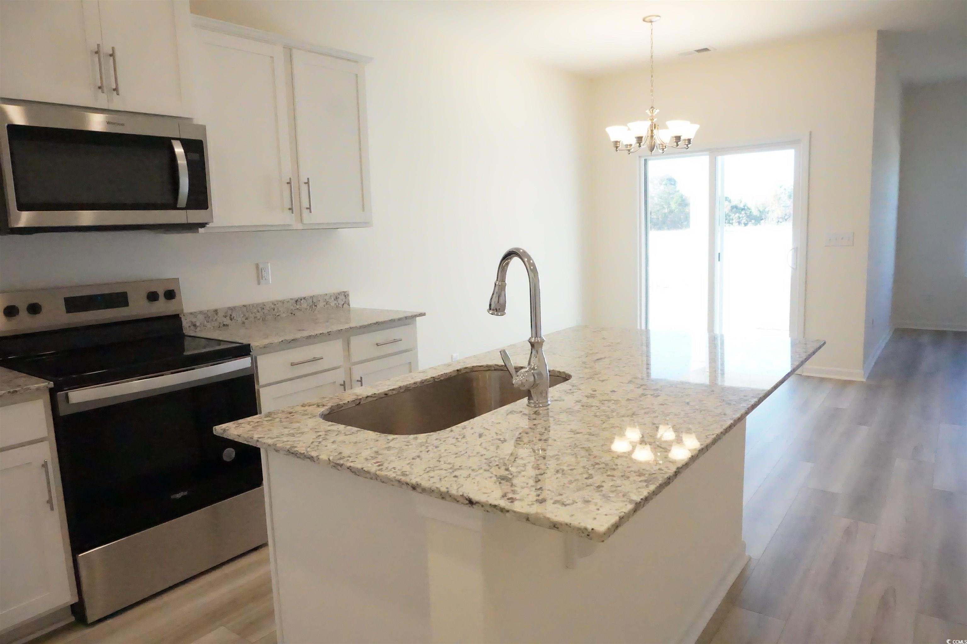 420 Hallie Martin Road Conway, SC 29527 - Photo 7 of 20 Kitchen with white cabinetry, a kitchen island wit