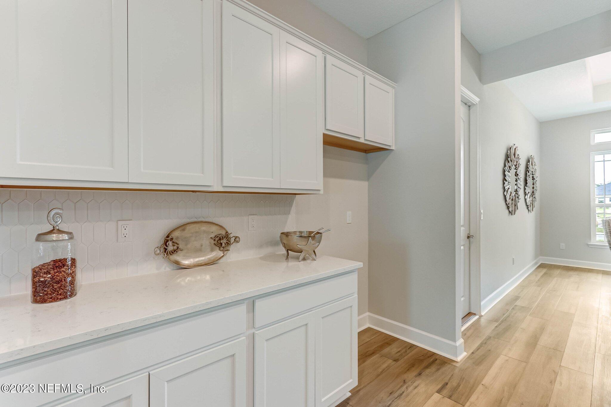 85156 Sandy Ridge Loop, Unit 18 Yulee, FL 32097 - Photo 13 of 25 a view of cabinets a sink and wooden floor in a kitchen
