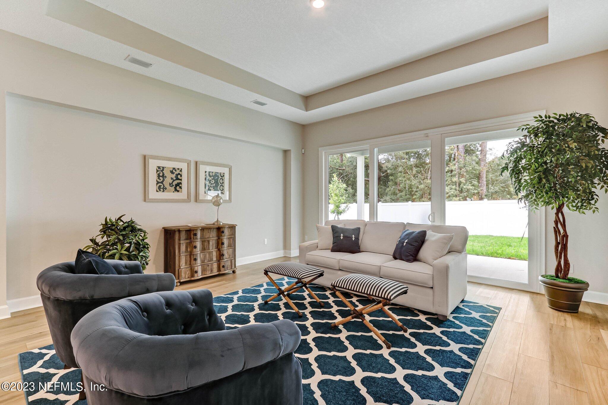 85156 Sandy Ridge Loop, Unit 18 Yulee, FL 32097 - Photo 14 of 25 a living room with furniture and a large window