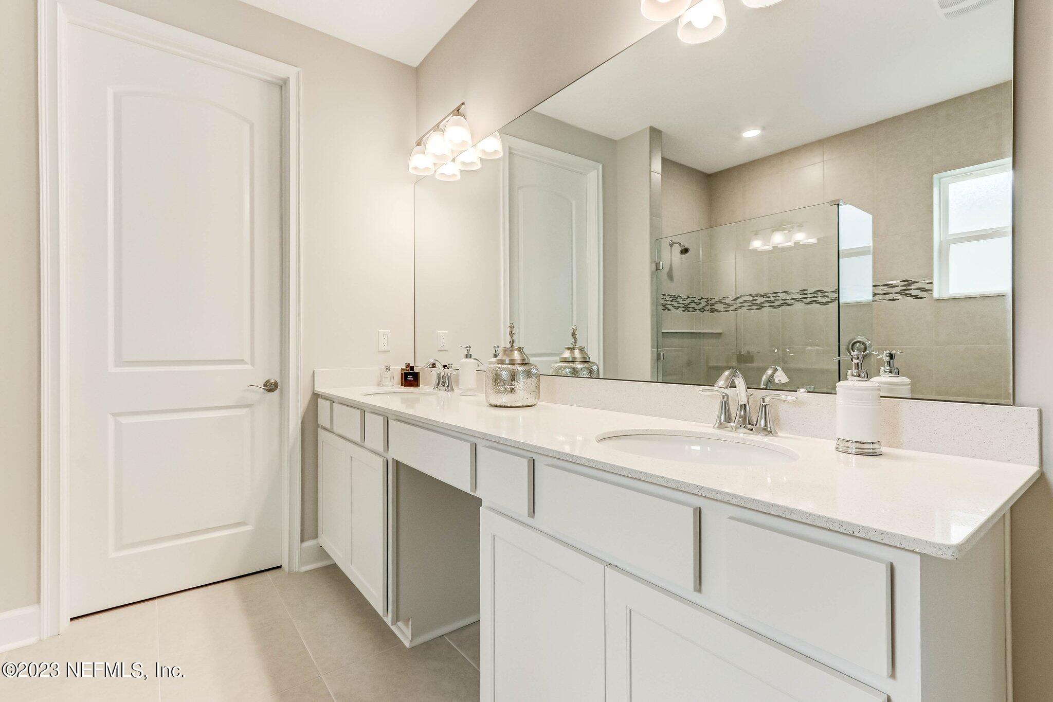 85156 Sandy Ridge Loop, Unit 18 Yulee, FL 32097 - Photo 17 of 25 a bathroom with a double vanity sink mirror and