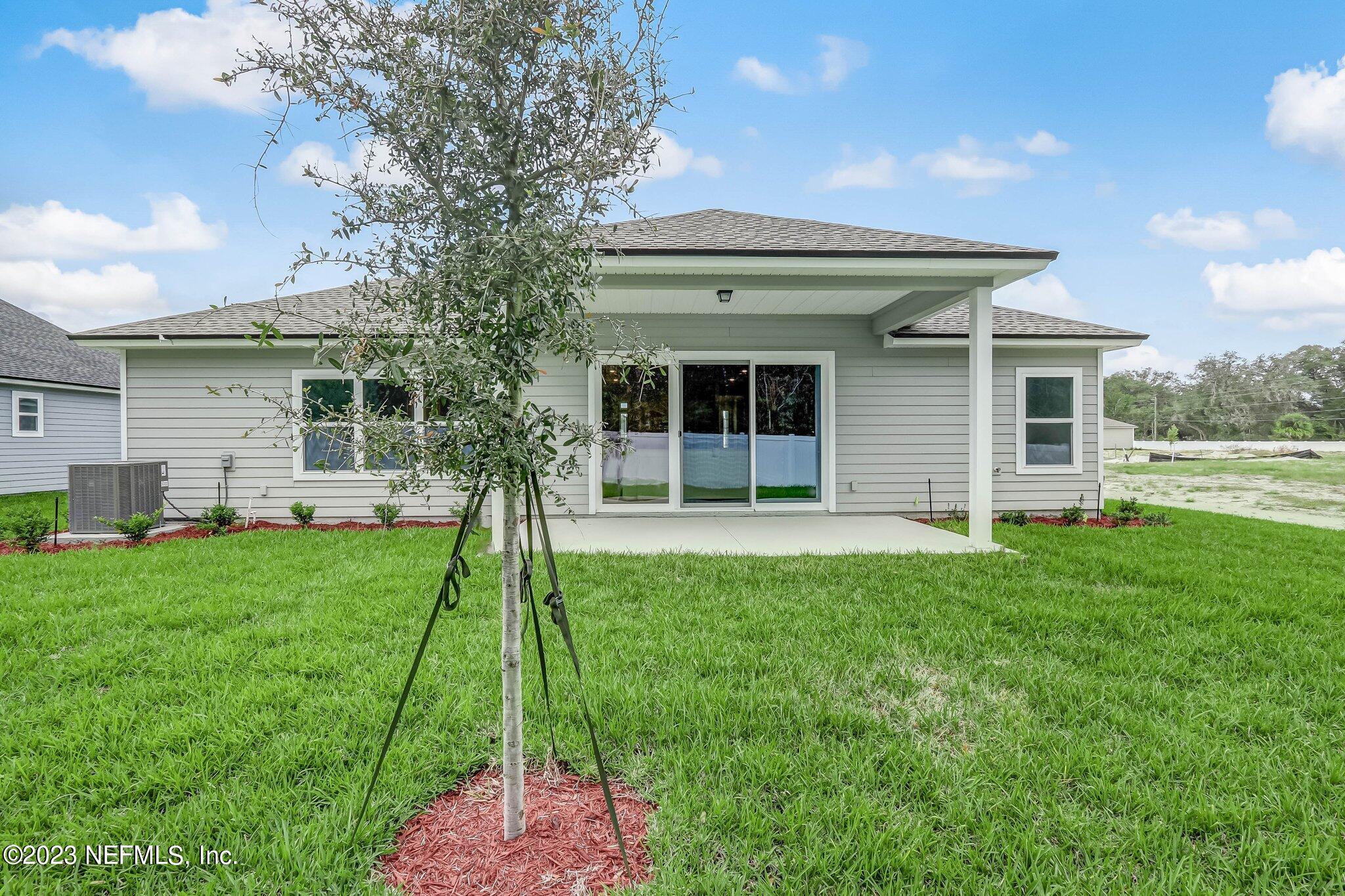 85156 Sandy Ridge Loop, Unit 18 Yulee, FL 32097 - Photo 25 of 25 a front view of a house with a yard