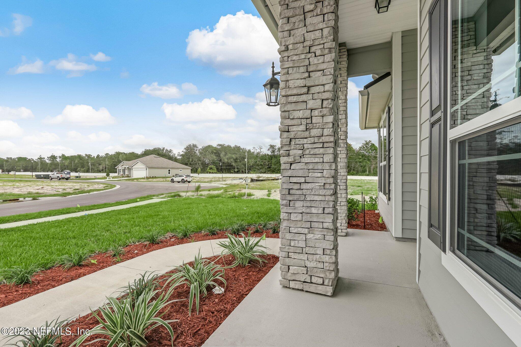 85156 Sandy Ridge Loop, Unit 18 Yulee, FL 32097 - Photo 5 of 25 a view of a balcony with floor to ceiling windows with wooden floor