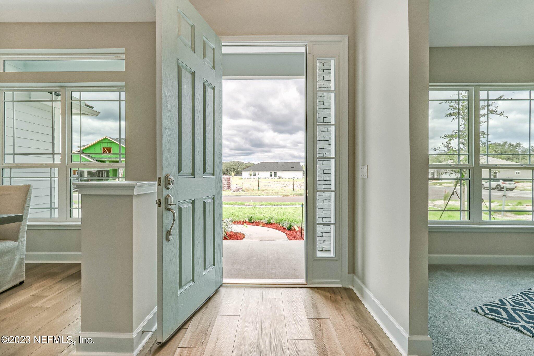 85156 Sandy Ridge Loop, Unit 18 Yulee, FL 32097 - Photo 6 of 25 a view of a hallway view with wooden floor and windows