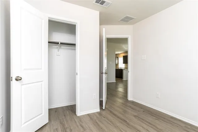 a view of hallway with wooden floor