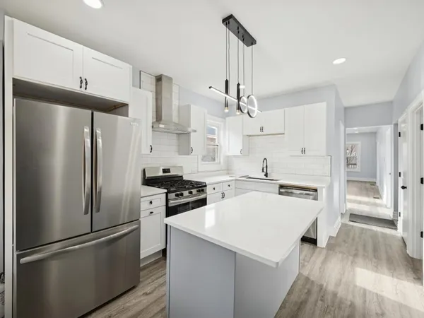 a kitchen with stainless steel appliances a refrigerator sink and cabinets