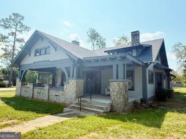 a front view of a house with garden