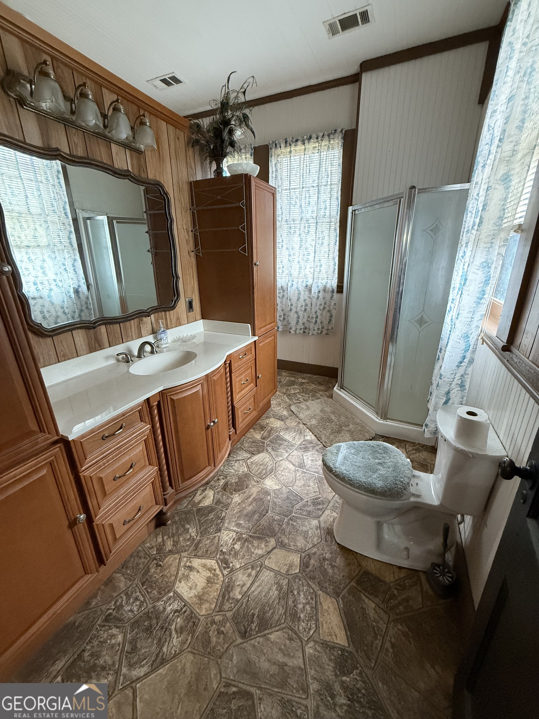 55 Hatcher Street Kite, GA 31049 - Photo 13 of 32 a bathroom with a sink toilet and shower