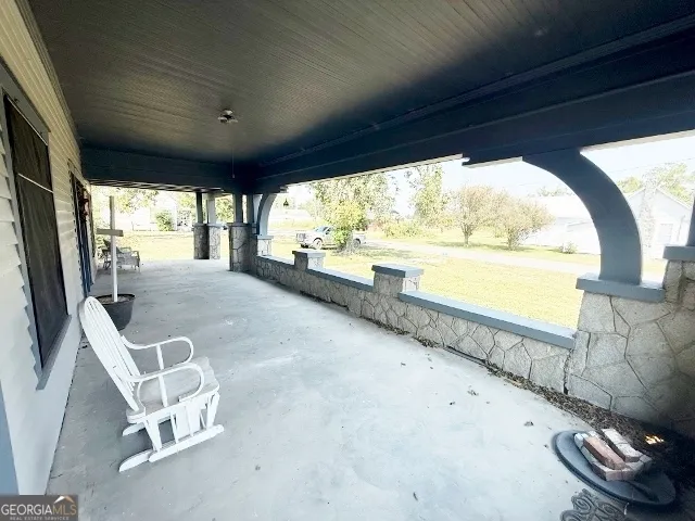 a view of an empty room with a floor to ceiling window