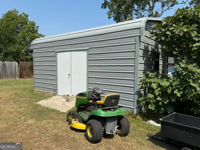 a backyard of a house with table and chairs
