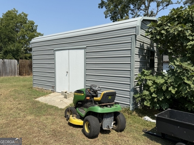 55 Hatcher Street Kite, GA 31049 - Photo 22 of 32 a backyard of a house with table and chairs