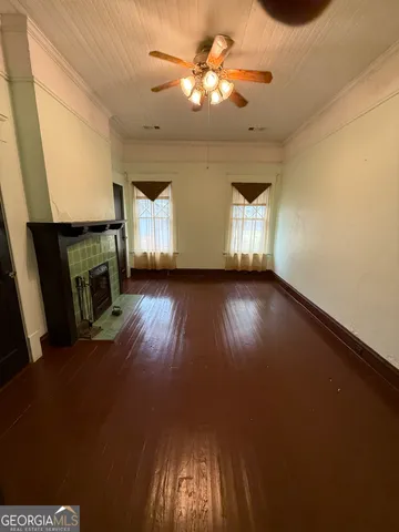 a view of a livingroom with a fireplace and window