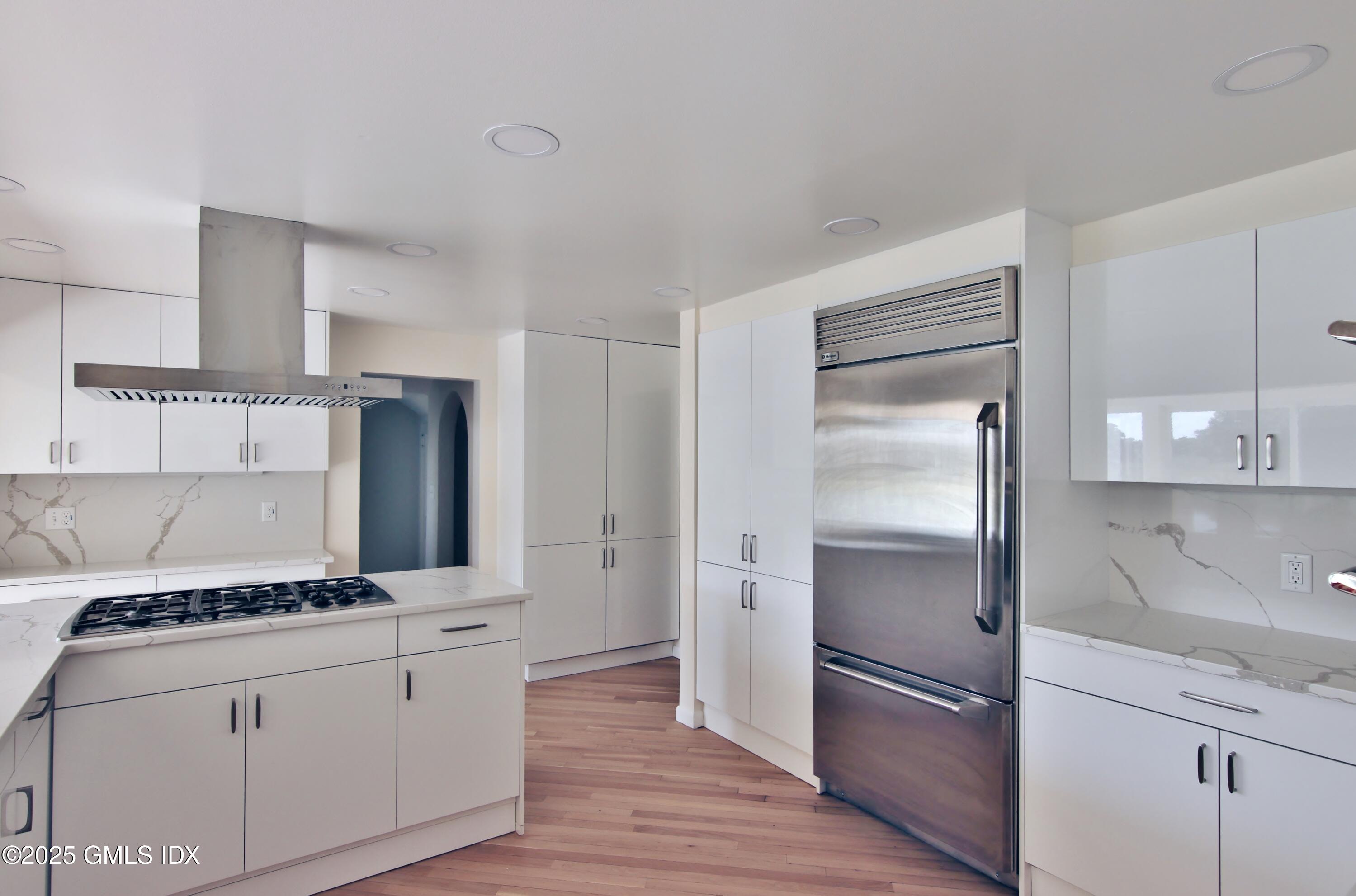 420 Davis Avenue Greenwich, CT 06830 - Photo 11 of 35 a kitchen with a refrigerator and a stove top oven