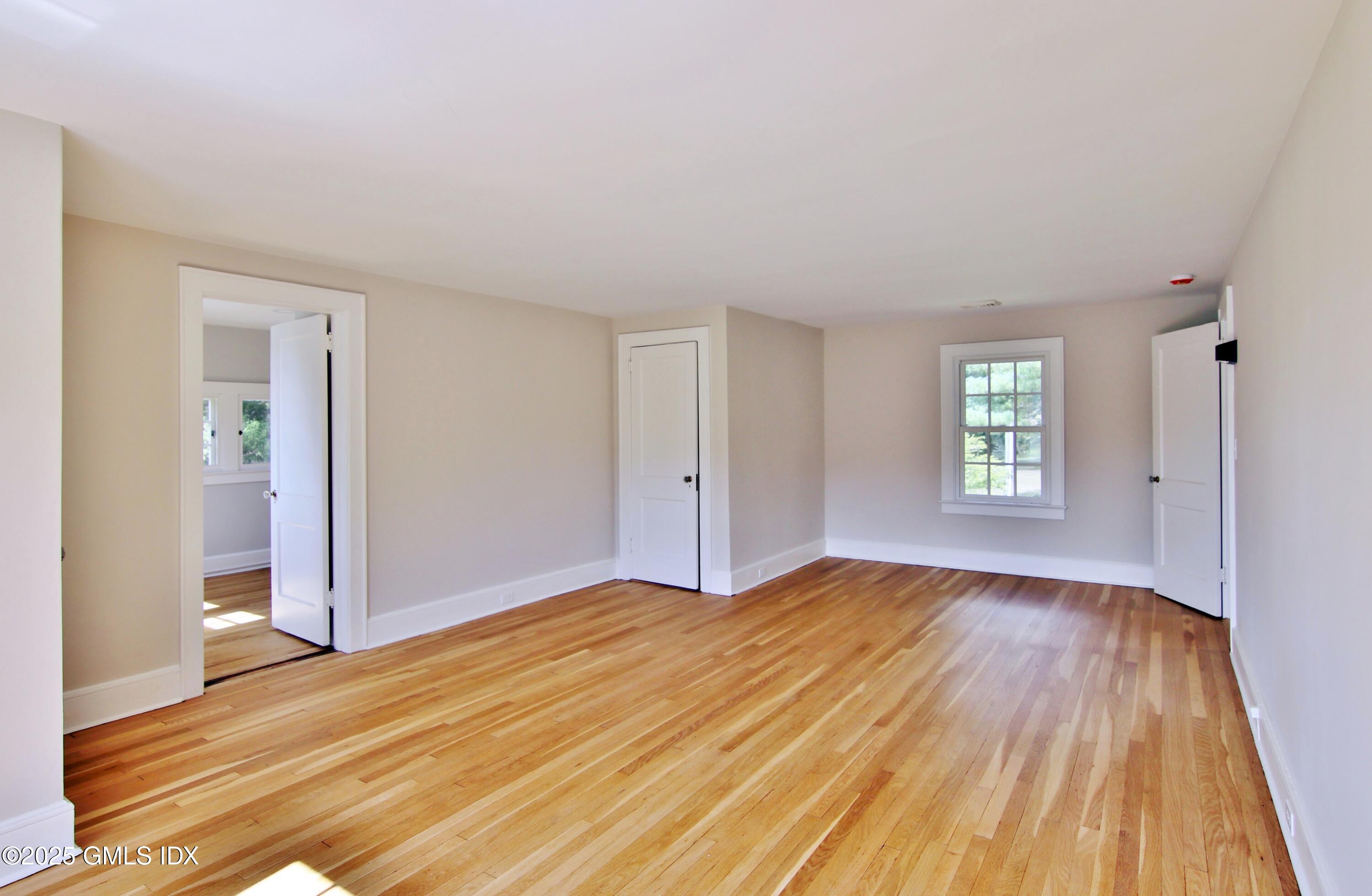 420 Davis Avenue Greenwich, CT 06830 - Photo 22 of 35 an empty room with wooden floor and windows