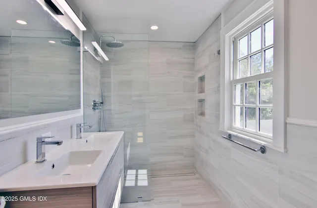 a bathroom with a sink shower and a bathtub