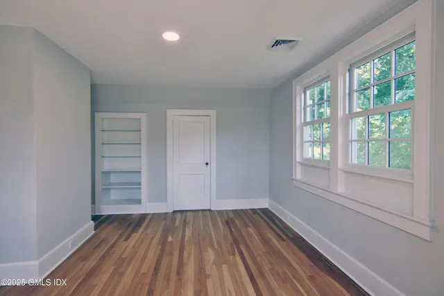 a view of room with window and hardwood floor