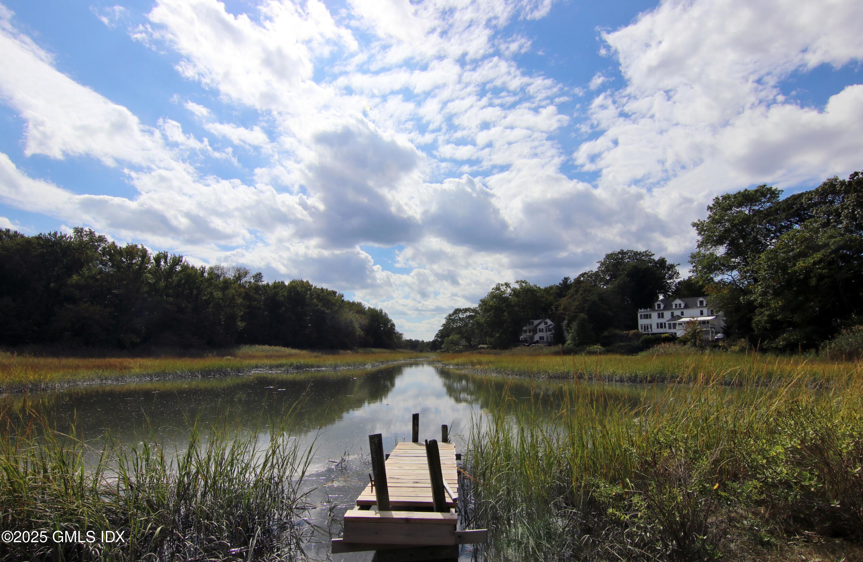 420 Davis Avenue Greenwich, CT 06830 - Photo 33 of 35 a view of a lake with houses in the back