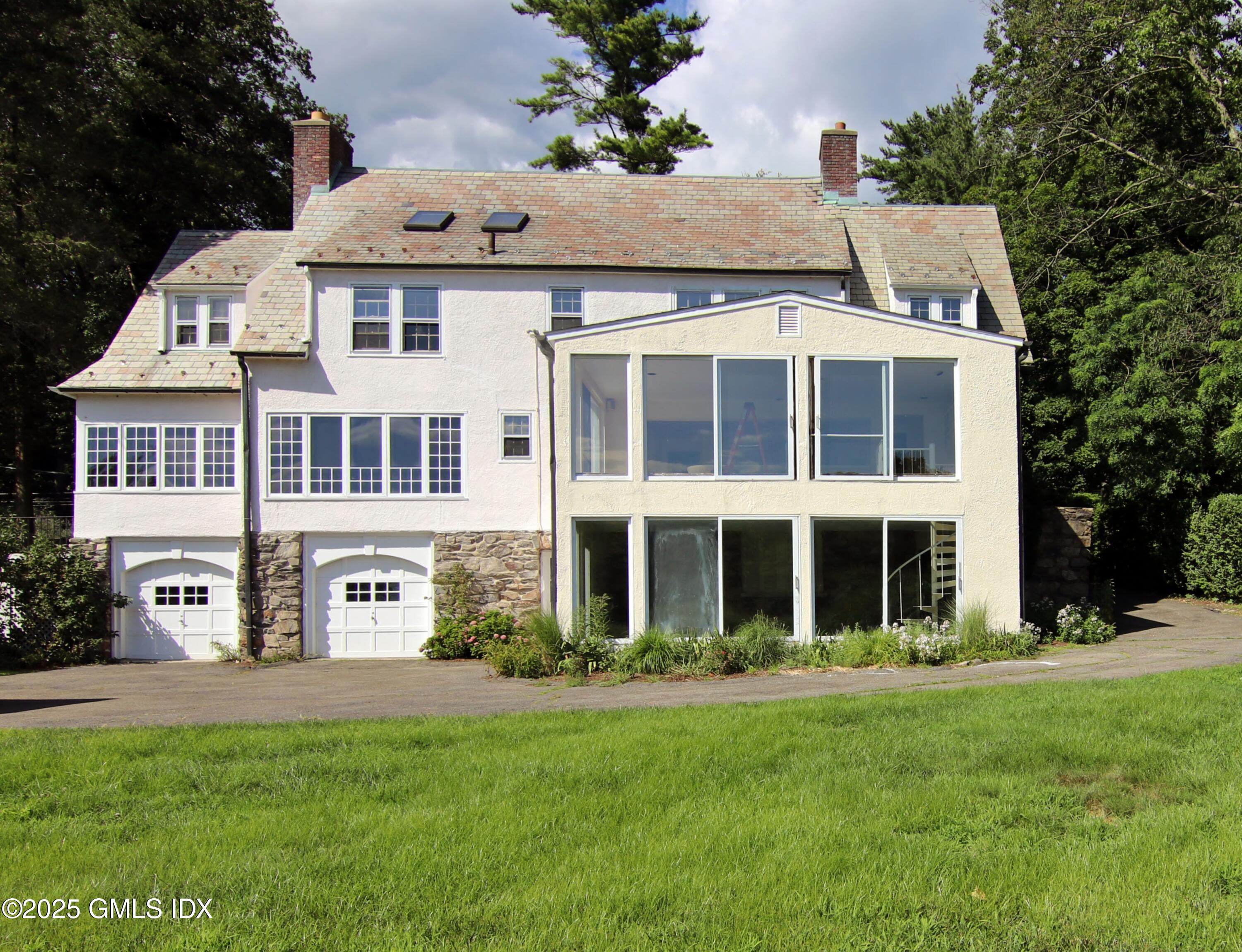 420 Davis Avenue Greenwich, CT 06830 - Photo 35 of 35 a front view of a house with a yard