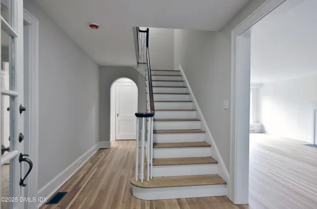 a view of entryway and hall with wooden floor