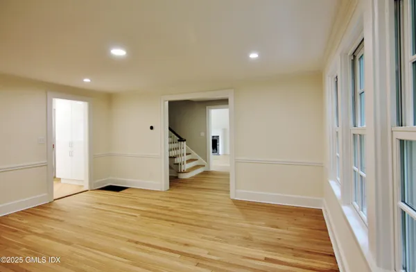 a view of a livingroom with wooden floor and white doors