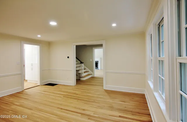 a view of a livingroom with wooden floor and white doors