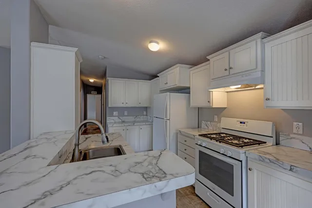 a kitchen with a sink appliances and cabinets