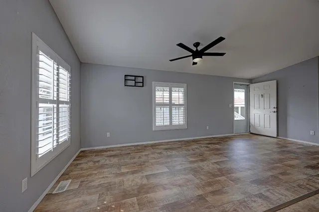 a view of a livingroom with a window and a ceiling fan