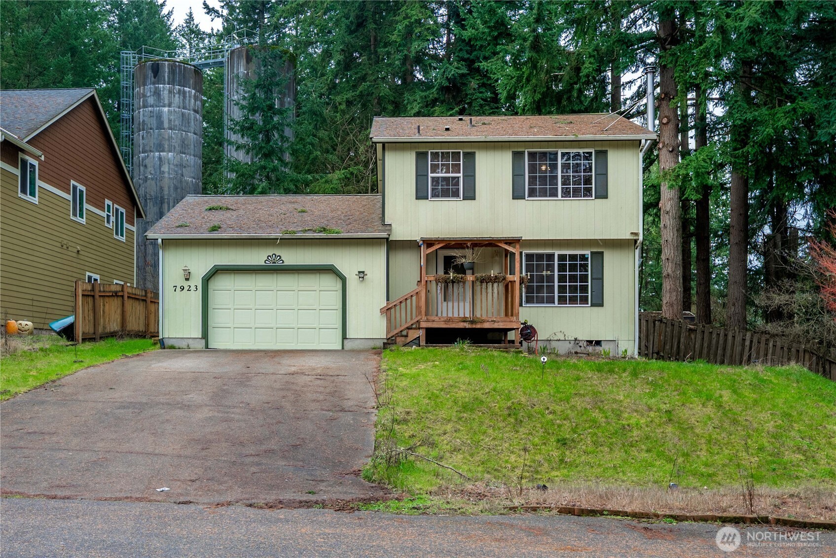 a view of a house with a yard and garage