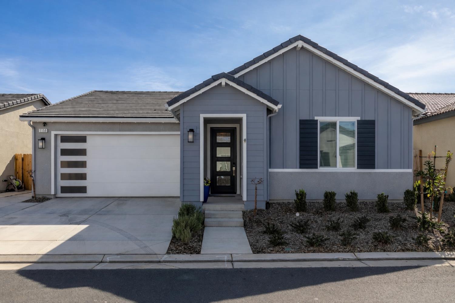 1158 Encore Way West Madera, CA 93636 - Photo 1 of 45 a front view of a house with garage