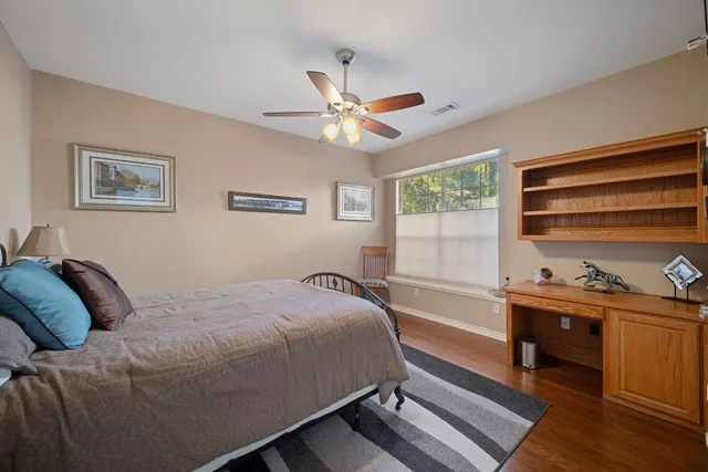 a front view of a house with a garden and patio